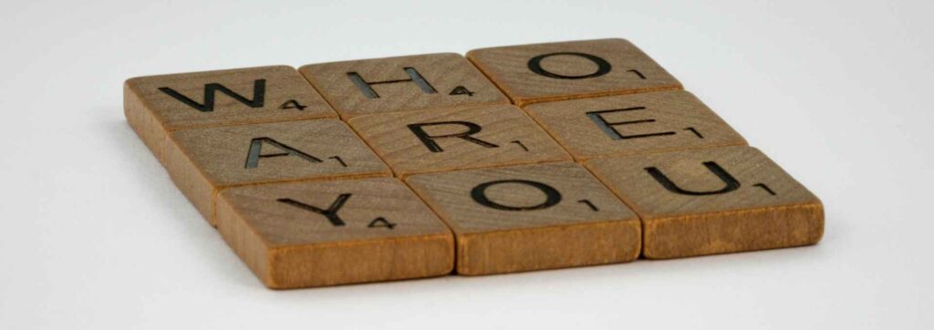 Scrabble letters that say "Who are you".